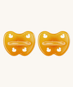 A two-pack of Hevea symmetrical teat baby pacifiers, made from 100% natural rubber and plastic-free. Both in natural orange