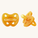 A two-pack of Hevea symmetrical teat baby pacifiers, made from 100% natural rubber and plastic-free. Both in a natural orange
