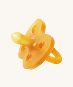 The Hevea natural rubber pacifier dummy with a symmetrical nipple shape, in a natural orange colour