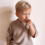 Close up of a young boy touching the Hevea natural rubber dummy in his mouth