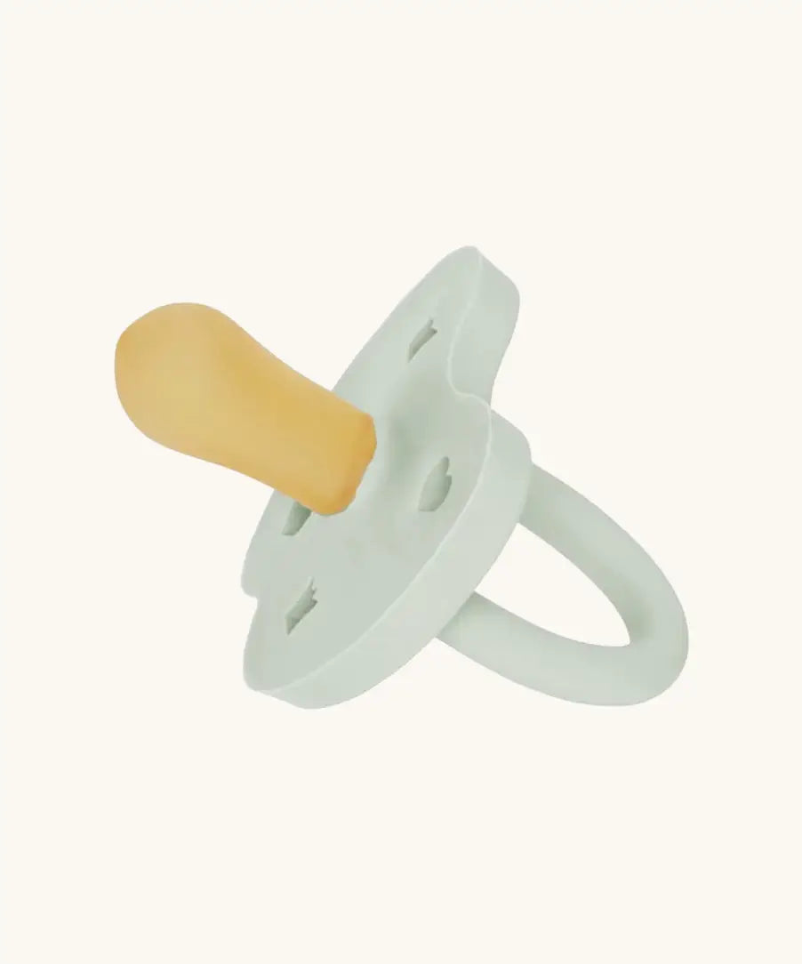 The Hevea natural rubber pacifier dummy in soft pebble green with a symmetrical nipple shape.
