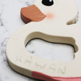 Close up of Hevea Natural Rubber Teether - Kawan the Duck  on a white marble background