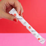 hey Girls Regular Absorbency Cardboard Applicator Tampons. Image shows a person with red nail varnish holding a tampon in its packet