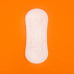 Hey Girls Natural Bamboo & Corn Fibre Disposable Panty Liner open on an orange background