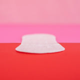 Hey Girls Natural Bamboo & Corn Fibre Disposable Panty Liners open in a persona hand on a red and pink background