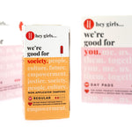 Close up of the Hey Girls non applicator tampons box next to some Hey Girls day pads on a white background