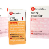 Close up of the Hey Girls non applicator tampons box next to some Hey Girls day pads on a white background