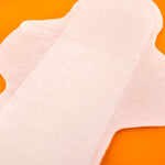 Hey Girls Natural Bamboo & Corn Fibre Disposable pads packaged on a pink background
