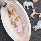 Holztiger wooden Noah's ark showing the removable lid off and a adult hand picking up a tiger figure inside