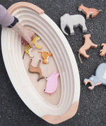 Holztiger wooden Noah's ark showing the removable lid off and a adult hand picking up a tiger figure inside