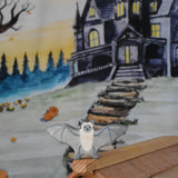 A Holztiger wooden bat toy figure placed on a ridge of the Ostheimer wooden cottage. A Wonderie Halloween trick or treat play cloth can be seen covering the wall behind.
This wooden toy figure is part of a wide range of Holztiger figures and scenery perfect for small world play available here at Babipur 
