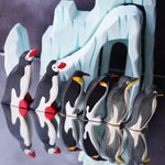 Bumbu and Ostheimer penguin figures lined up with a dark coloured background behind