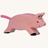 Holztiger Running Piglet Toy on a plain background. 