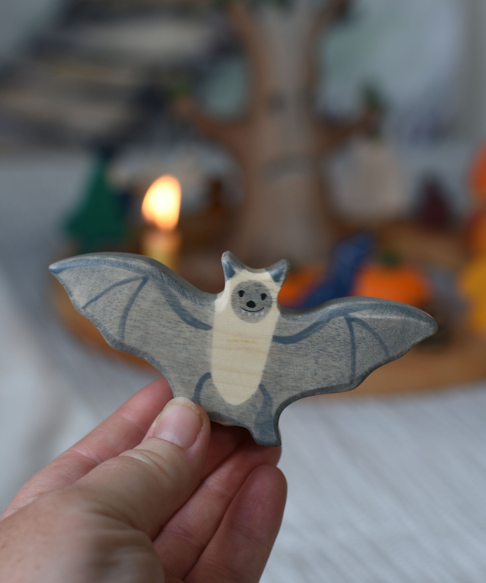 A Holztiger wooden bat toy figure held in an adult's hand to show scale.
This wooden toy figure is part of a wide range of Holztiger figures and scenery perfect for small world play available here at Babipur 