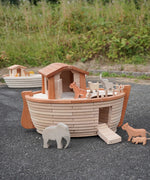 Holztiger handcrafted wooden XL Noah's ark with different animals on top  and side ramp down. Smaller ark in the background