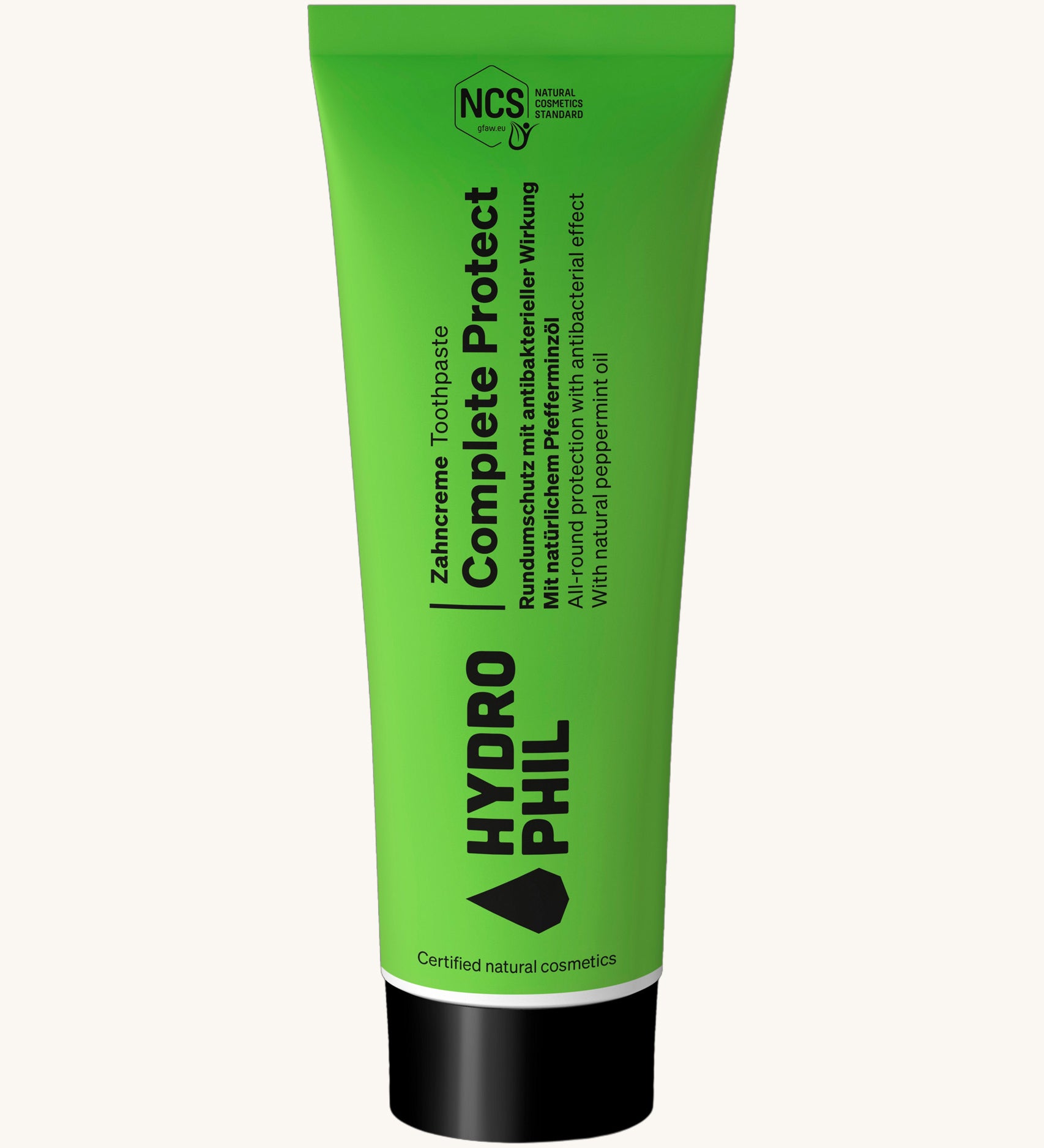 Hydrophil Complete Protect Toothpaste in a green tube with natural cosmetics certification and ingredient information on the front. 