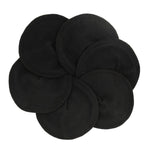 Imse Vimse reusable organic cotton black nursing breast pads laid out in a circle on a white background