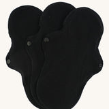 Imse Vimse black coloured Active Regular reusable Period Pads pictured on a plain background