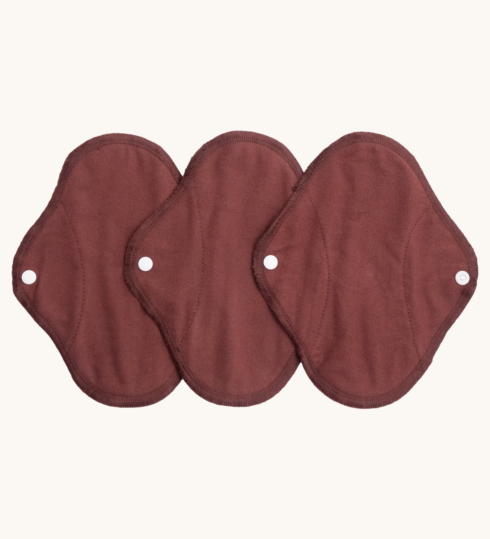 Imse Vimse warm brown panty liner reusable period pads available at Babipur. A 100% organic cotton pad with a white popper fastener