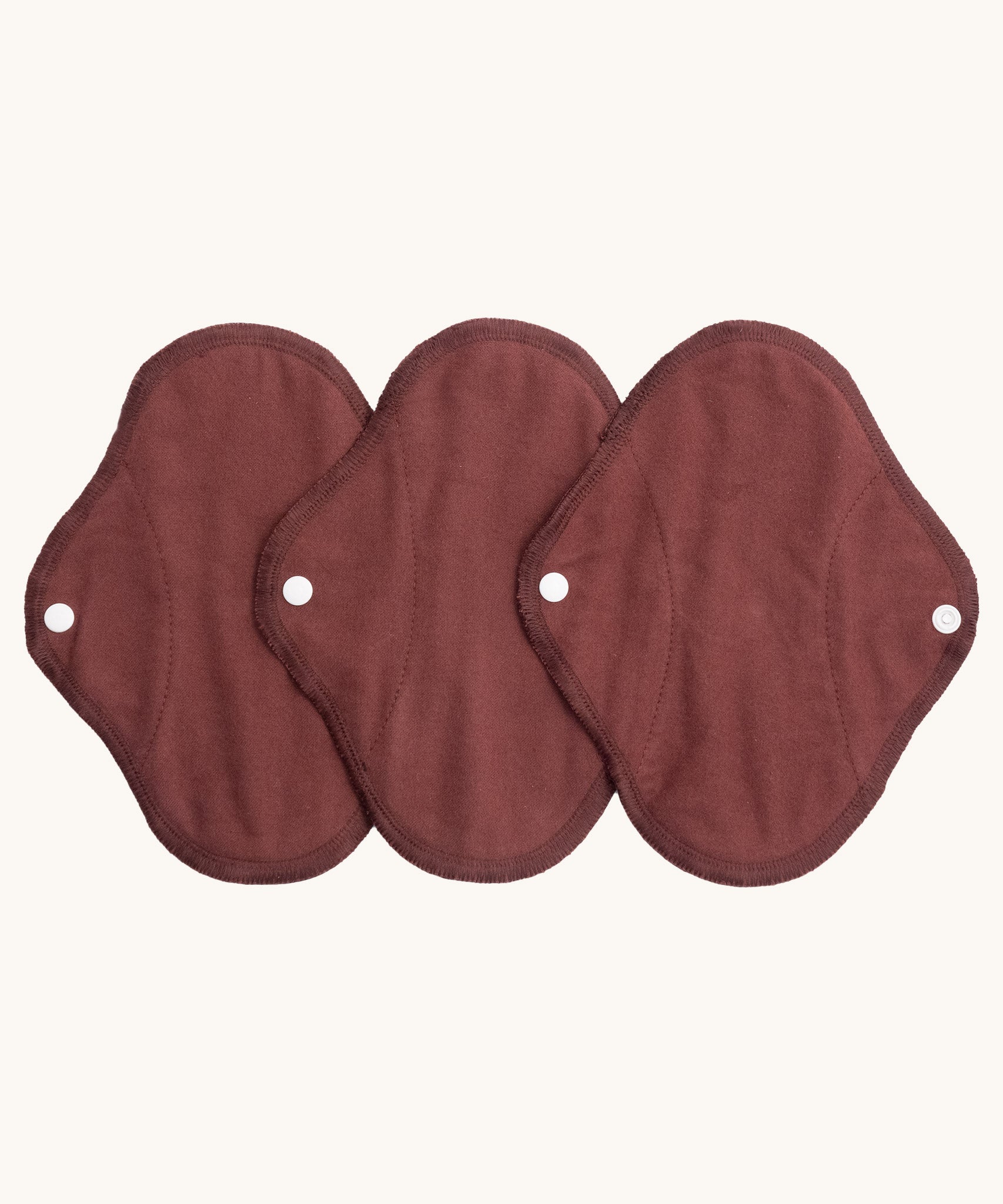 Imse Vimse warm brown panty liner reusable period pads available at Babipur. A 100% organic cotton pad with a white popper fastener