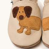 A close up of the Inch Blue cream dash shoes available at Babipur showing the brown suede cut out dachshund design