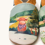 A close up of the Inch Blue highland cow shoes available at Babipur showing  a closer look at the highland cow design