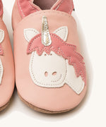 A close up of the Inch Blue pink unicorn baby shoes available at Babipur showing the white and pink unicorn cutout design