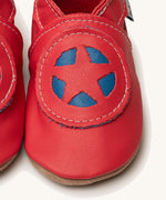 A close up of the Inch Blue superkid red baby shoes available at Babipur. Showing the red and blue star shield design