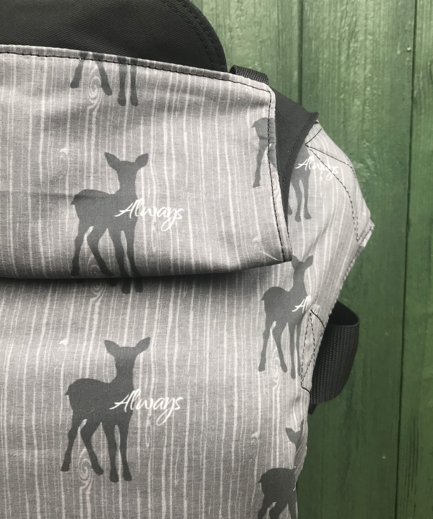 A close up of the deer silhouette design and hood detail on the Integra always baby carrier available at Babipur.