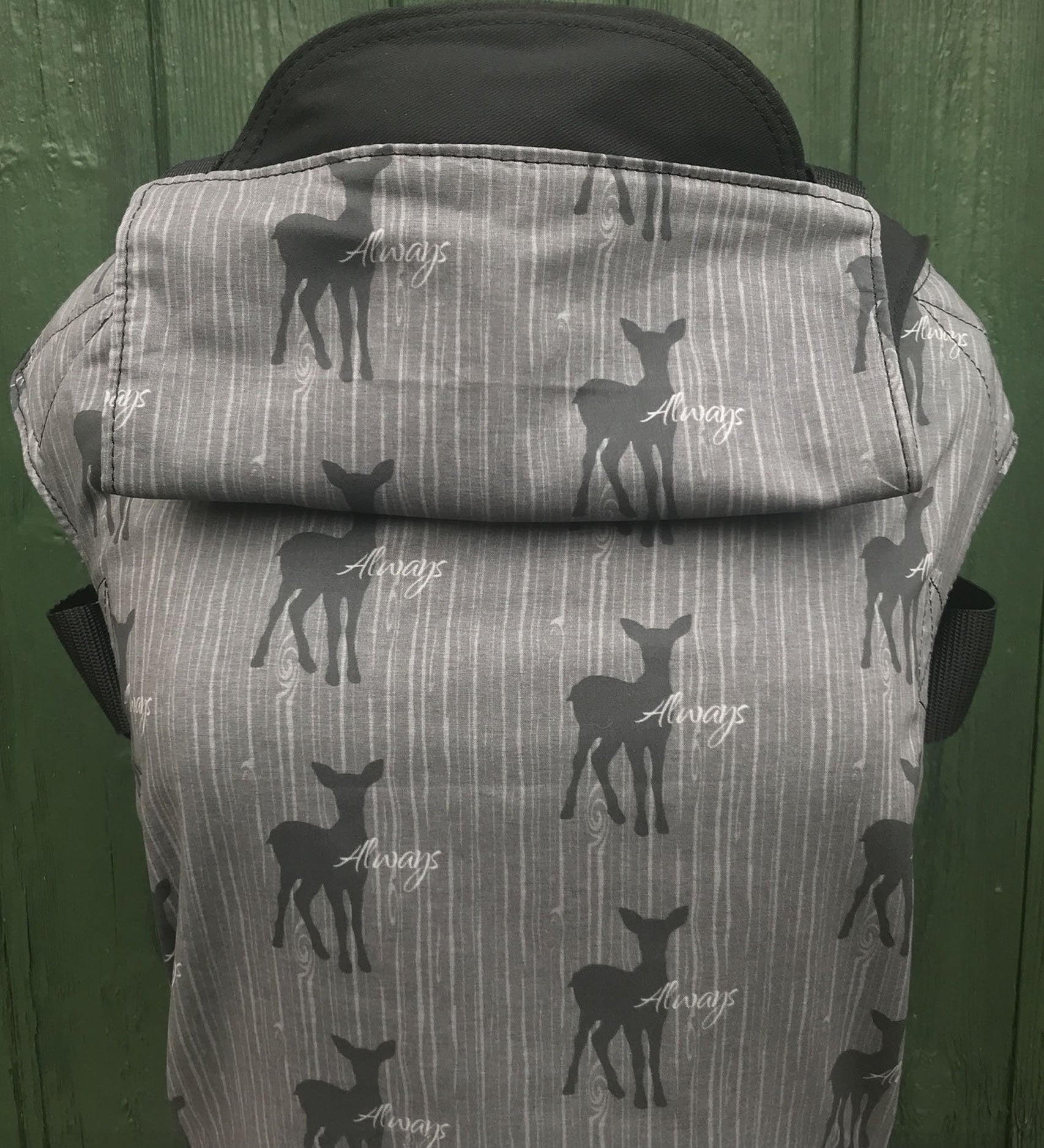 Integra always design baby carrier available at a Babipur.  A grey carrier with a deer silhouette design and 'Always' slogan. Features a small hood for head protection.