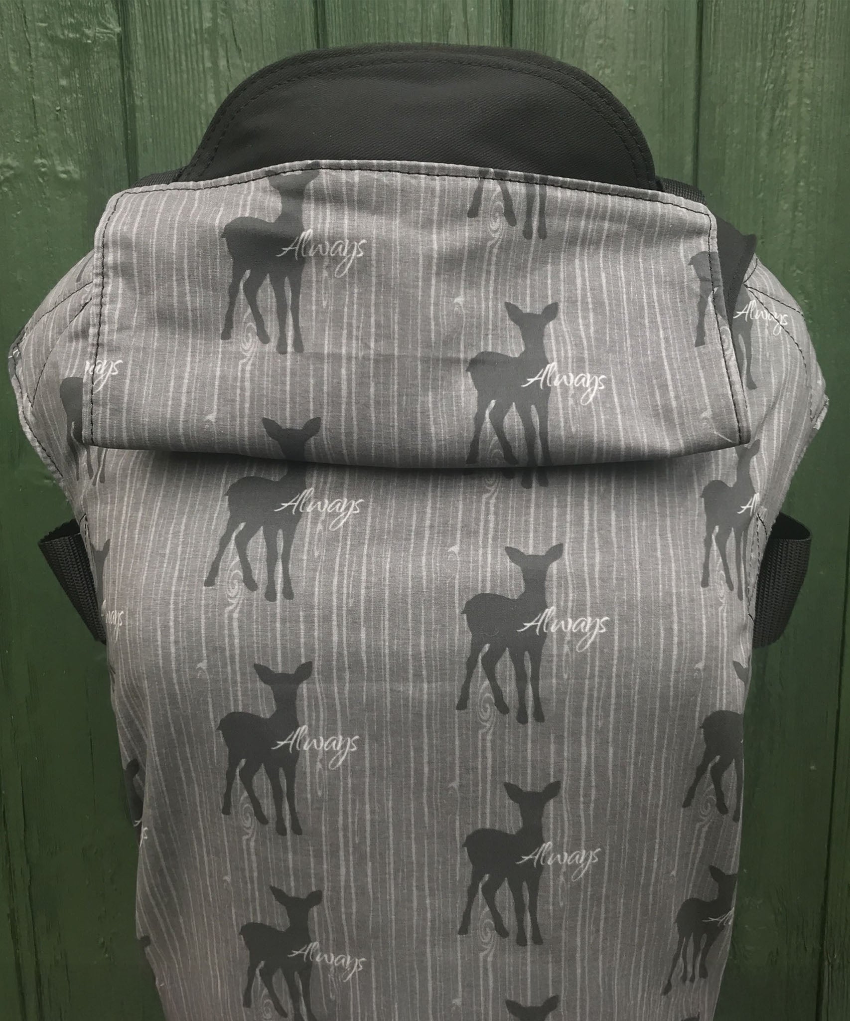 Integra always design baby carrier available at a Babipur.  A grey carrier with a deer silhouette design and 'Always' slogan. Features a small hood for head protection.