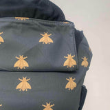 A close up of the golden bee design and hood detail on the Integra bee baby carrier available at a Babipur.  