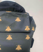 A close up of the golden bee design and hood detail on the Integra bee baby carrier available at a Babipur.  