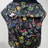 Integra flower garden baby carrier available at a Babipur a dark coloured carrier with a vintage inspired flower and butterfly design. Features a small hood for head protection.