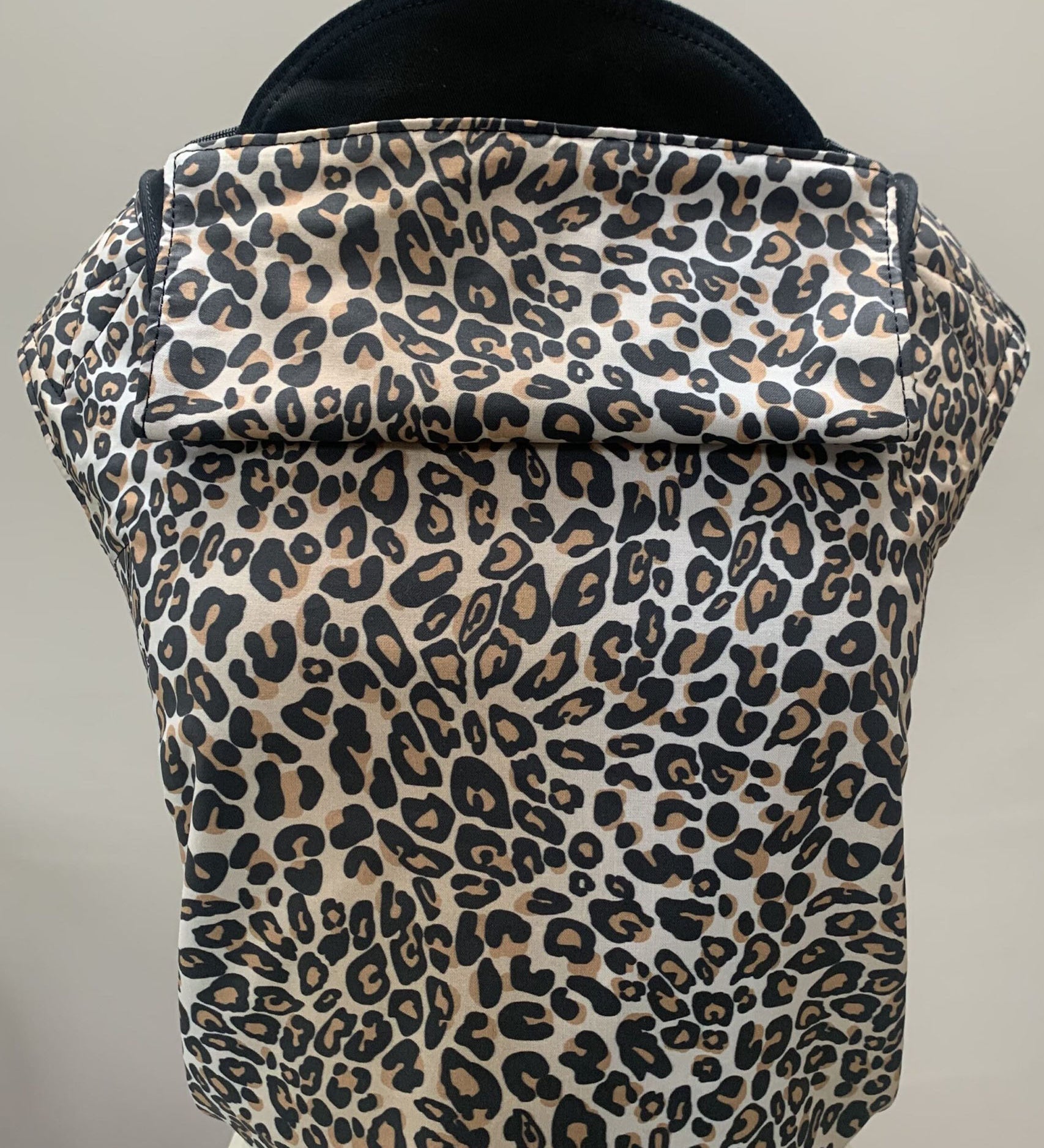 Integra leopard design baby carrier available at a Babipur. Features a small hood for head protection.