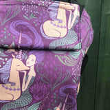 A close up of the beautiful mermaid and unicorn design on the Integra memraid and unicorn baby carrier available at Babipur.