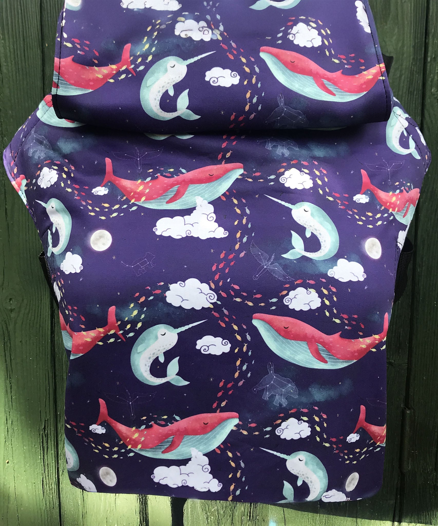 Integra ocean slumber baby carrier available at a Babipur a dark coloured carrier with playful sleeping whales design. Features a small hood for head protection