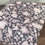 Integra Peta baby carrier available at a Babipur a dark coloured carrier with a pink floral design. Features a small hood for head protection.