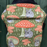 Integra shelter baby carrier available at a Babipur a green coloured carrier with a vintage mouse and toadstool design. Features a small hood for head protection.