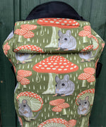 Integra shelter baby carrier available at a Babipur a green coloured carrier with a vintage mouse and toadstool design. Features a small hood for head protection.