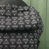 A close up of the white geometric diamond print and hood detail on the Integra shine bright baby carrier available at Babipur.