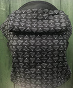 Integra shine bright design baby carrier available at a Babipur.  A black carrier with a geometric style diamond design. Features a small hood for head protection.