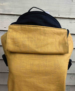 Integra ochre yellow texture linen baby carrier available at a Babipur. Features a small hood for head protection.