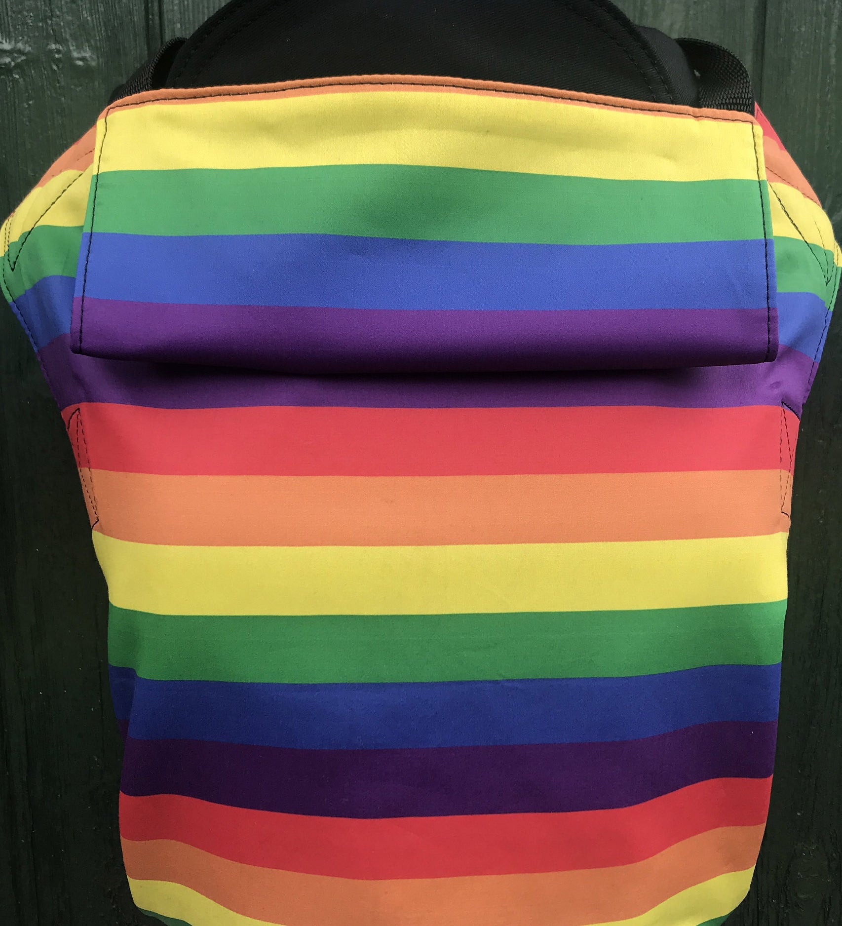 Integra rainbow baby carrier available at a Babipur a bold and bright rainbow inspired design carrier with a small hood for head protection.
