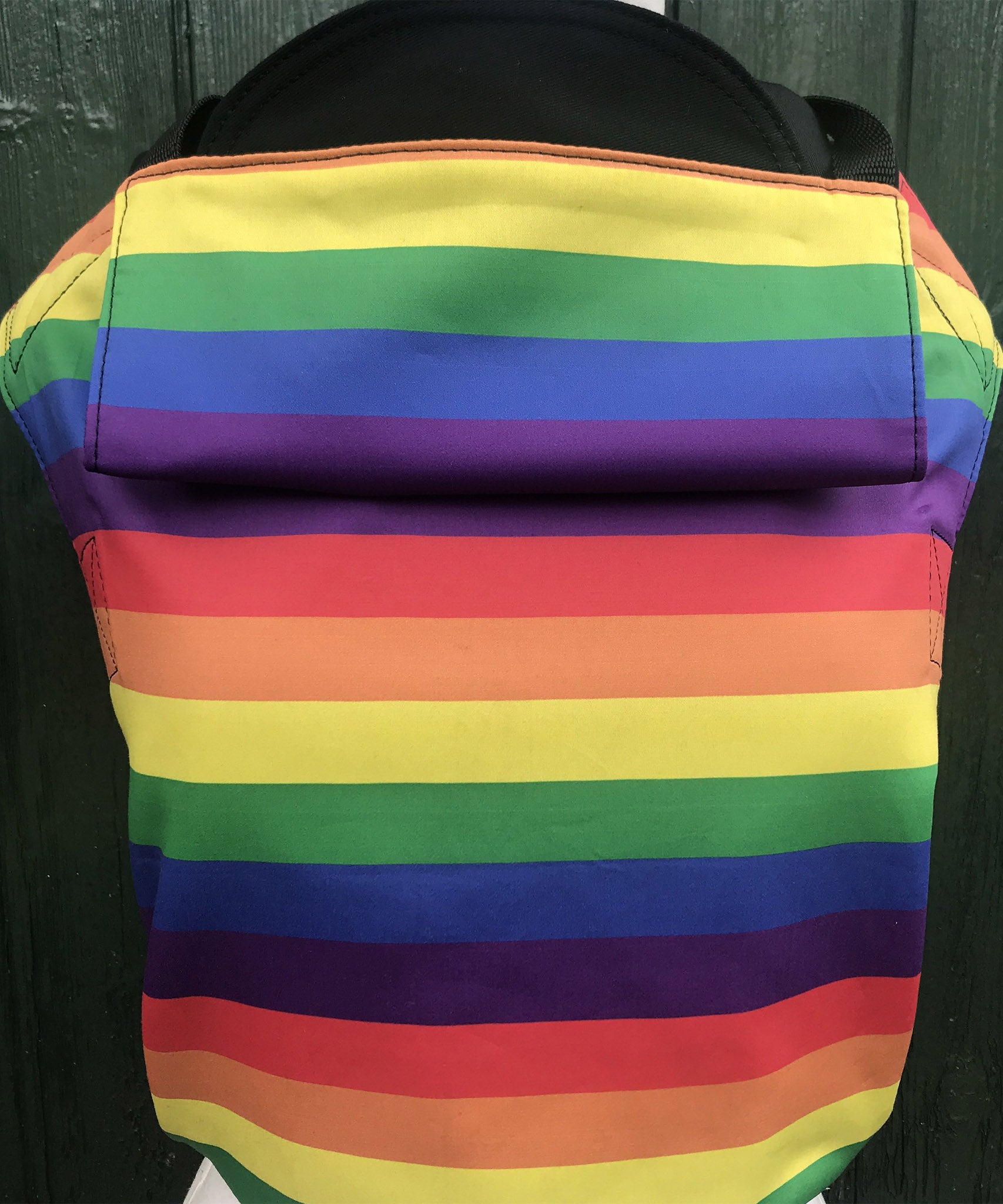 Integra rainbow baby carrier available at a Babipur a bold and bright rainbow inspired design carrier with a small hood for head protection.