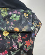 A close up of the flower garden design on the Integra flower garden baby carrier available at a Babipur
