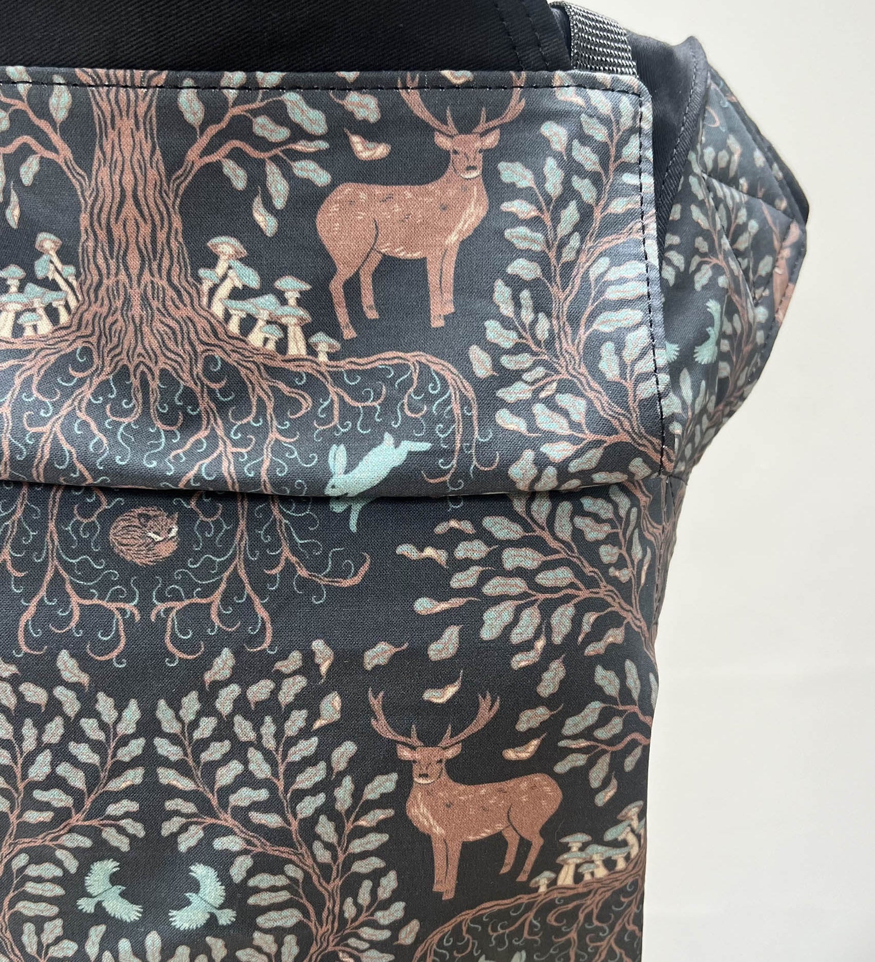 A close up of the beautiful reindeer in a forest design on the Integra forest tree baby carrier available at Babipur.