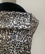 A close up of the leopard print and hood detail on the Integra baby carrier available at Babipur.