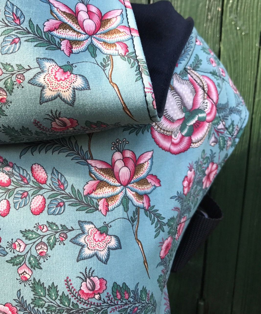 A close up of the Integra Martha baby carrier available at a Babipur showing the vintage pink floral design in detail