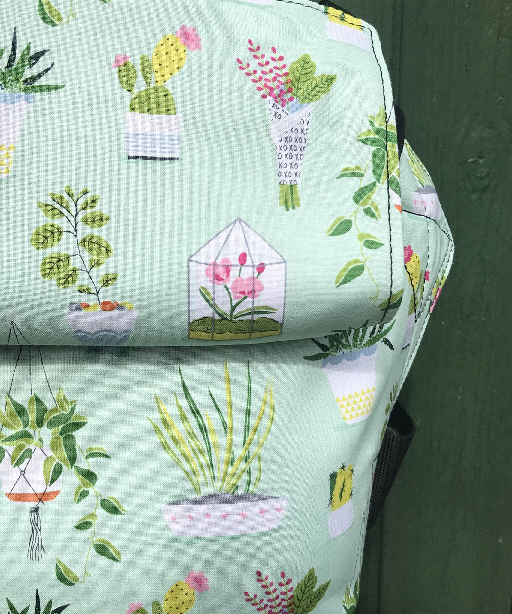 A close up of the house plants design on the Integra viva baby carrier available at a Babipur 